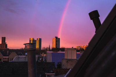 Silhouette buildings against sky during sunset