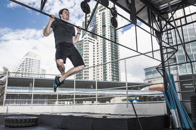 Man training at rooftop gym in bangkok