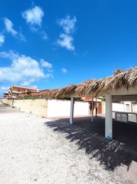 Built structure on beach against blue sky