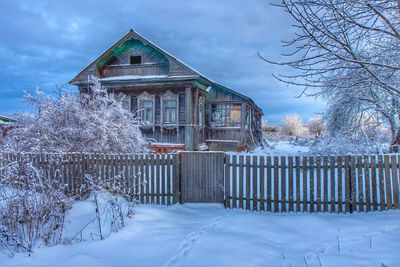 Built structure on snow covered land against sky