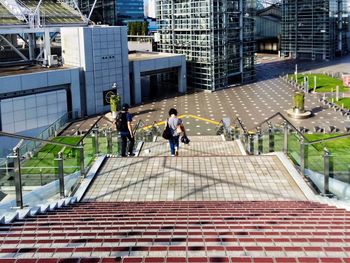 Rear view of people moving down on steps