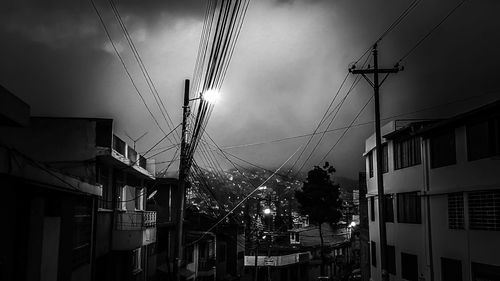 Low angle view of electricity pylon against sky