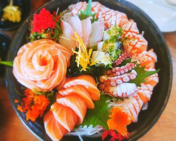 Directly above shot of sashimi in bowl on table