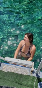 High angle view of woman in swimming pool on sunny day