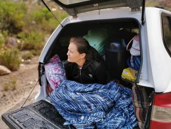 Midsection of woman sitting in car