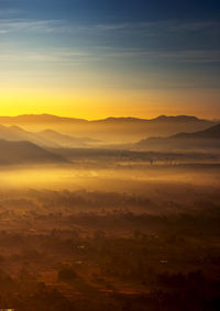 Scenic view of silhouette mountains against sky during sunset