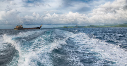 Boat sailing in sea against sky