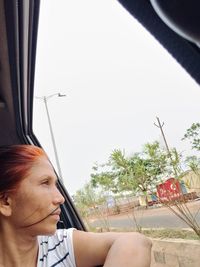 Woman sitting by window