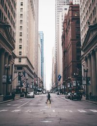 Rear view of woman walking on street in city