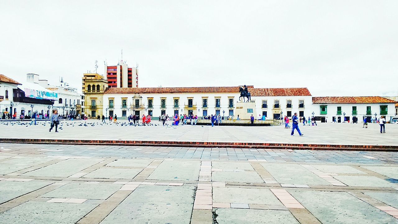 large group of people, architecture, built structure, building exterior, person, clear sky, men, mixed age range, lifestyles, leisure activity, tourist, walking, tourism, copy space, day, town square, travel destinations, famous place, travel