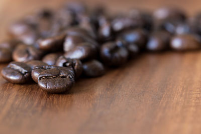 Close-up of roasted coffee beans on table