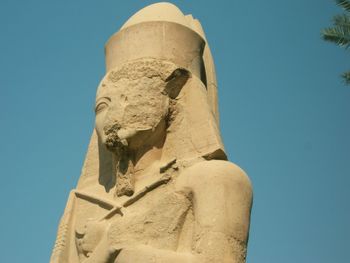 Low angle view of statue against clear blue sky