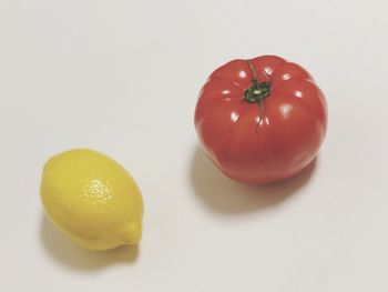 Close-up of orange fruit against white background
