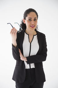 Portrait of young woman against white background