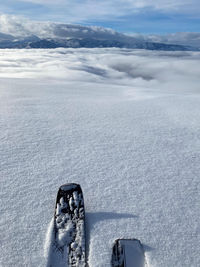 Snow covered landscape against sky