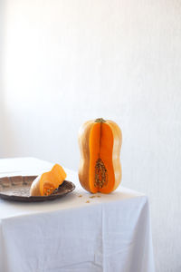 Close-up of pumpkin on table against white background