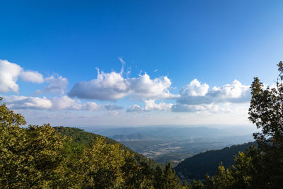 Scenic view of mountains against blue sky
