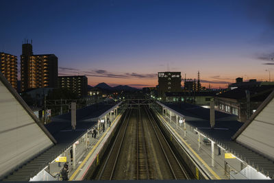 High angle view of illuminated railroad station against sky