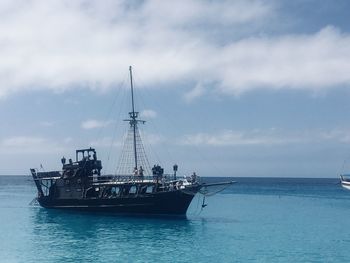 Sailboat sailing on sea against sky