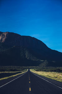Scenic view of mountains against clear blue sky