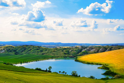 High angle view of lake amidst landscape against sky