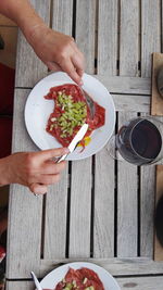 High angle view of woman eating food on table