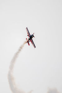 Low angle view of airplane flying against clear sky