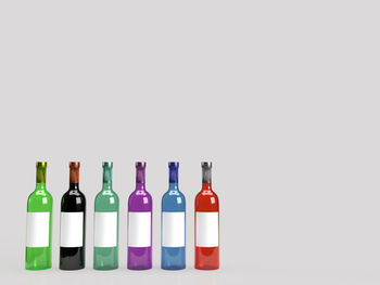 Multi colored bottles on white background