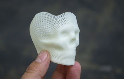 Cropped hand of woman wearing hat