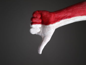 Close-up of human hand against black background