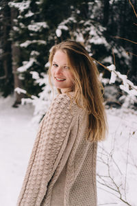 Portrait of smiling young woman during winter