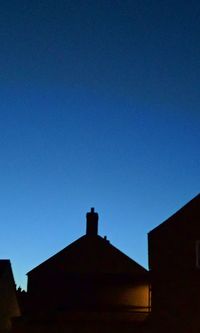 Low angle view of house against blue sky