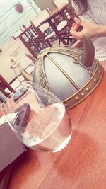 High angle view of woman drinking glass on table