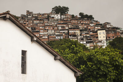 Buildings in town against clear sky