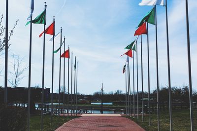 Multi colored flag by building against sky