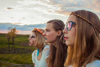 Portrait of a beautiful young woman against sky