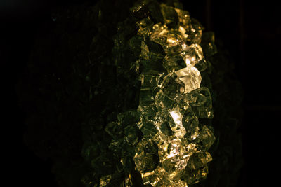 Close-up of illuminated lighting equipment against black background