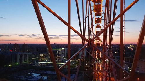 Bridge in city against sky during sunset