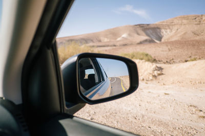 Reflection on side-view mirror of car