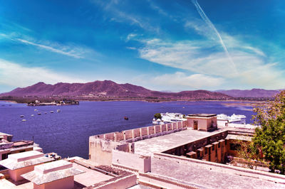 High angle view of sea and buildings against sky