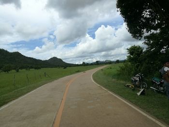 Road passing by landscape against sky