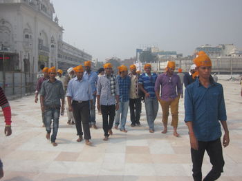 People on sidewalk in city