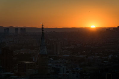 Cityscape against sky during sunset