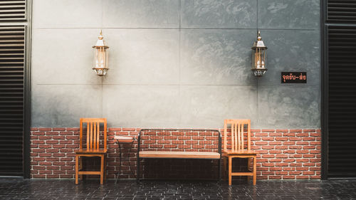 Empty chairs and tables against wall in building