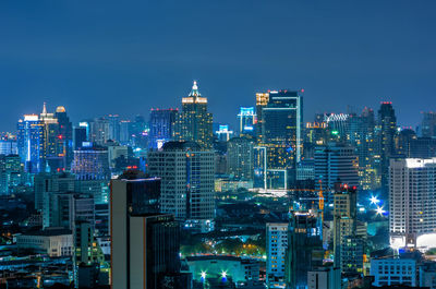 Illuminated cityscape against sky at night