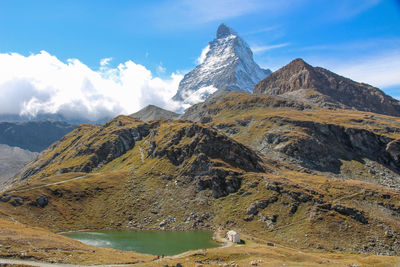 Scenic view of mountains against cloudy sky