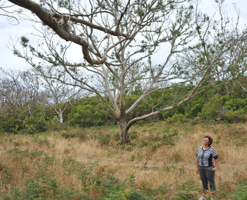 Full length of man standing on field in forest