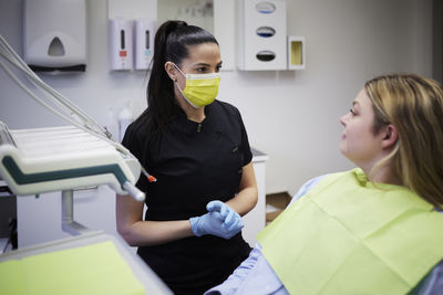 Female dentist with patient in office