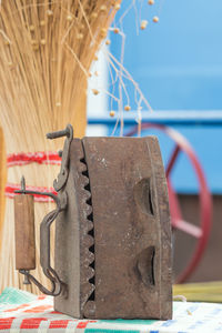 Close-up of abandoned iron on table