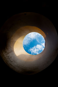 Low angle view of sky seen through hole
